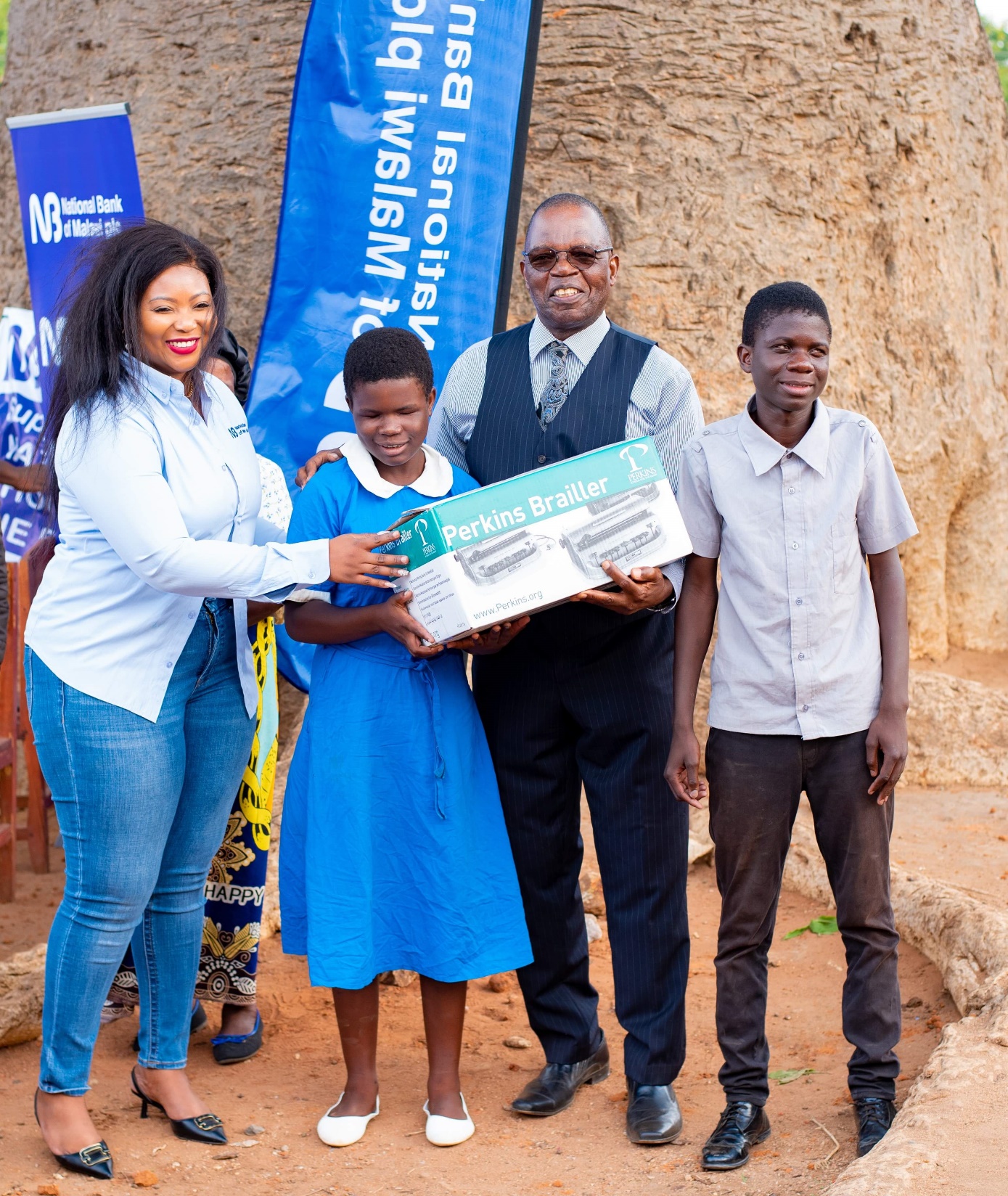 Hiwa handing over braille machine to Dr Lipenga and Nazombe learners