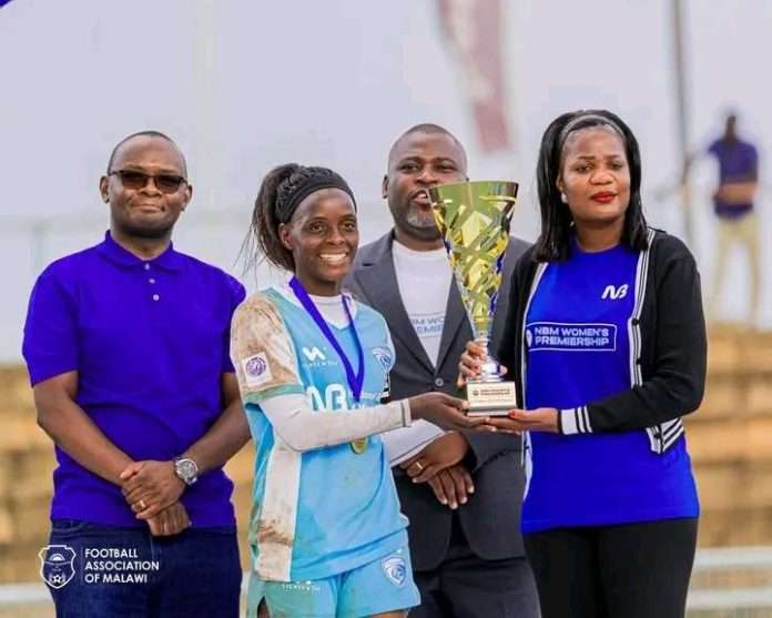 Wiskies presenting the trophy to Silver Strikers Ladies captain Nyirongo Wiskies presenting the trophy to Silver Strikers Ladies captain Nyirongo