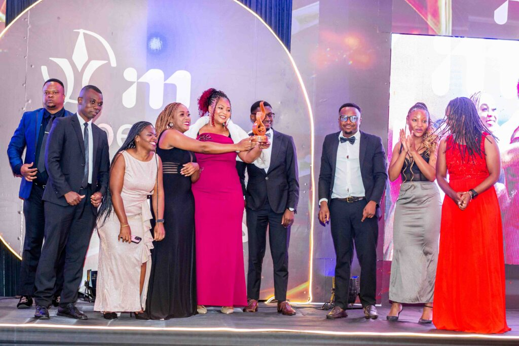 NBM plc’s Hiwa (middle) receiving Top Brand award in Financial Services-Banking category NBM plcs Hiwa middle receiving Top Brand award in Financial Services Banking category