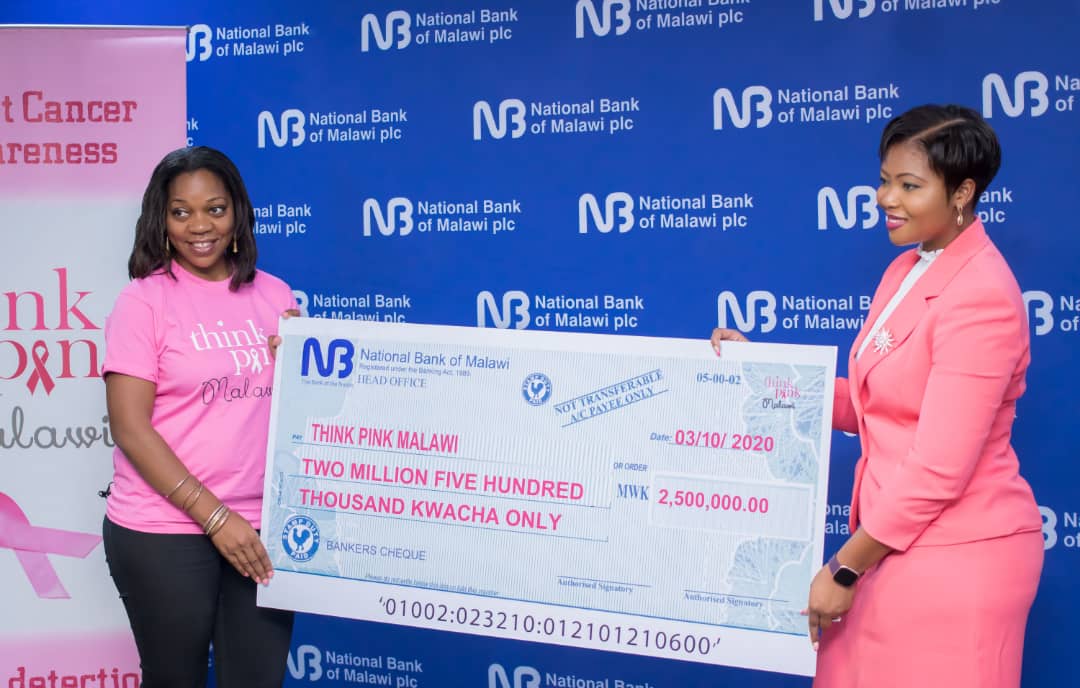 Akossa Hiwa (L) presents a dummy cheque to Nkosi