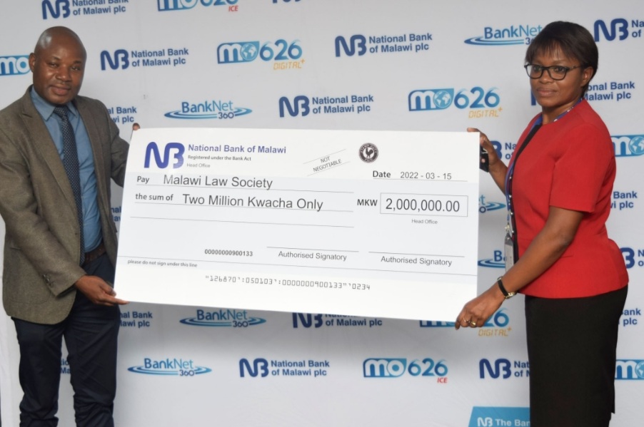 Mzati Mbeko (L) MLS Executive Director receiving cheque from Zunzo Mitole, NBM plc Company Secretary & Legal Counsel