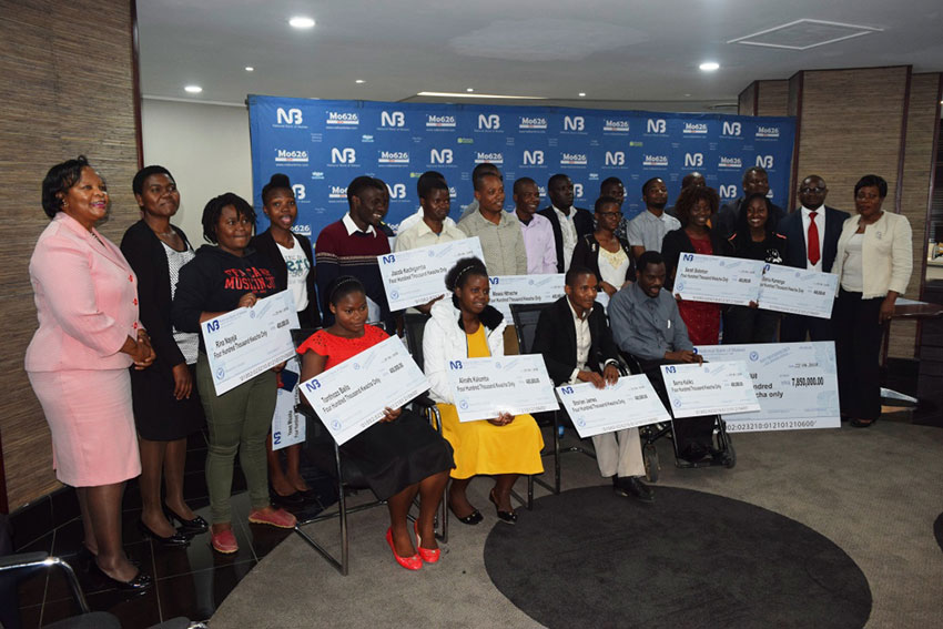 NBM officials pose with the students and Polytechnic staff and alumni